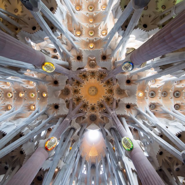 New York to Barcelona Horizontal image of the Sagrada Familia Cathedral ceiling with beautiful architectural design and amazing light in Barcelona, Spain.