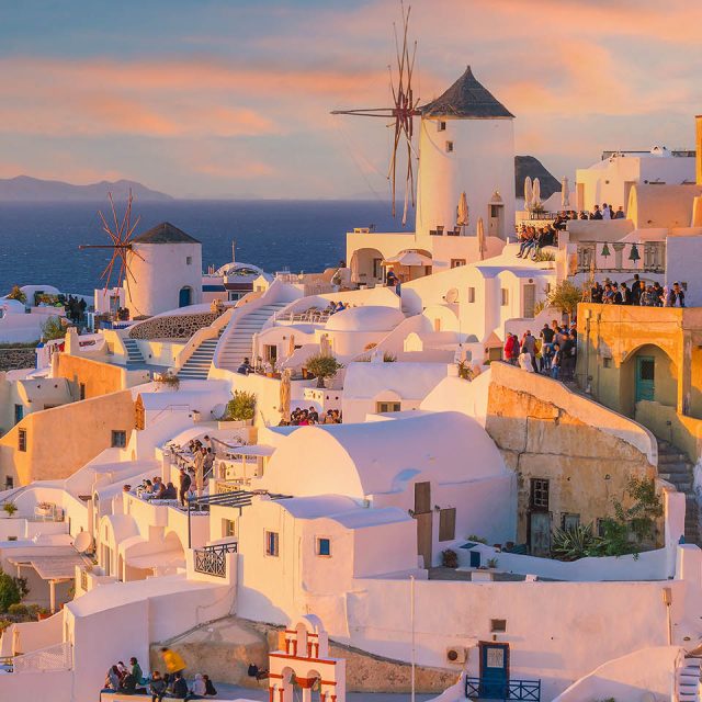 Greek Island Explorer Cityscape of Oia town in Santorini island, Greece. Panoramic view at the sunset.