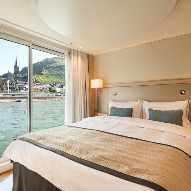 Grand European Tour Bedroom in an Veranda Suite onboard the Viking Longship Hlin with the town of Lorch am Rhein in the Upper Middle Rhine Valley in Germany out the window